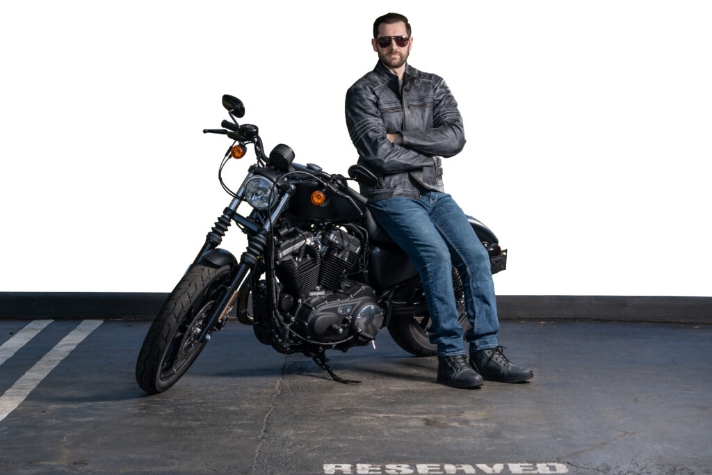 Kyle Bagen, Motorcycle Accident Lawyer, poses by his own motorcycle