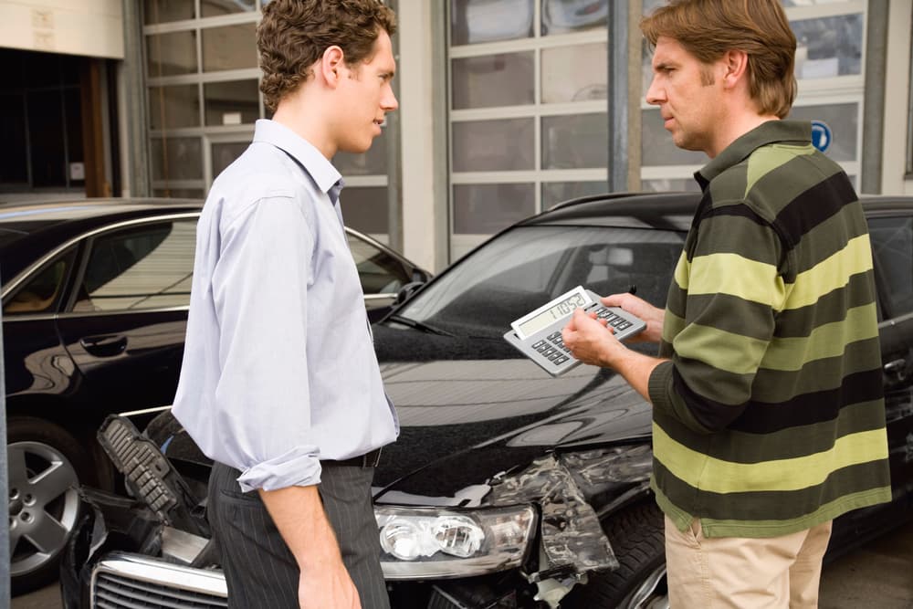 Claim Adjuster Showing Car Accident Settlement Amount