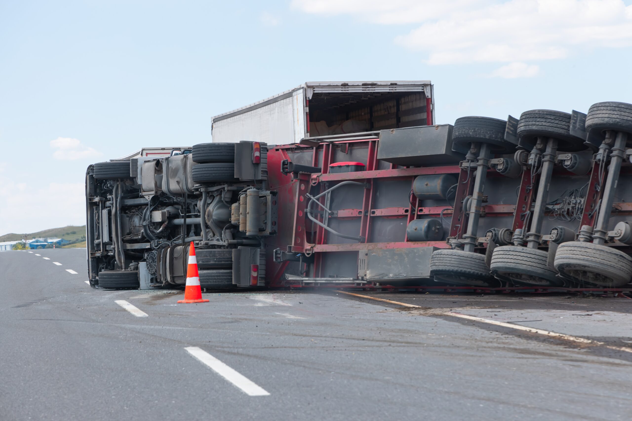 a large semi truck tipped over on the interstate
