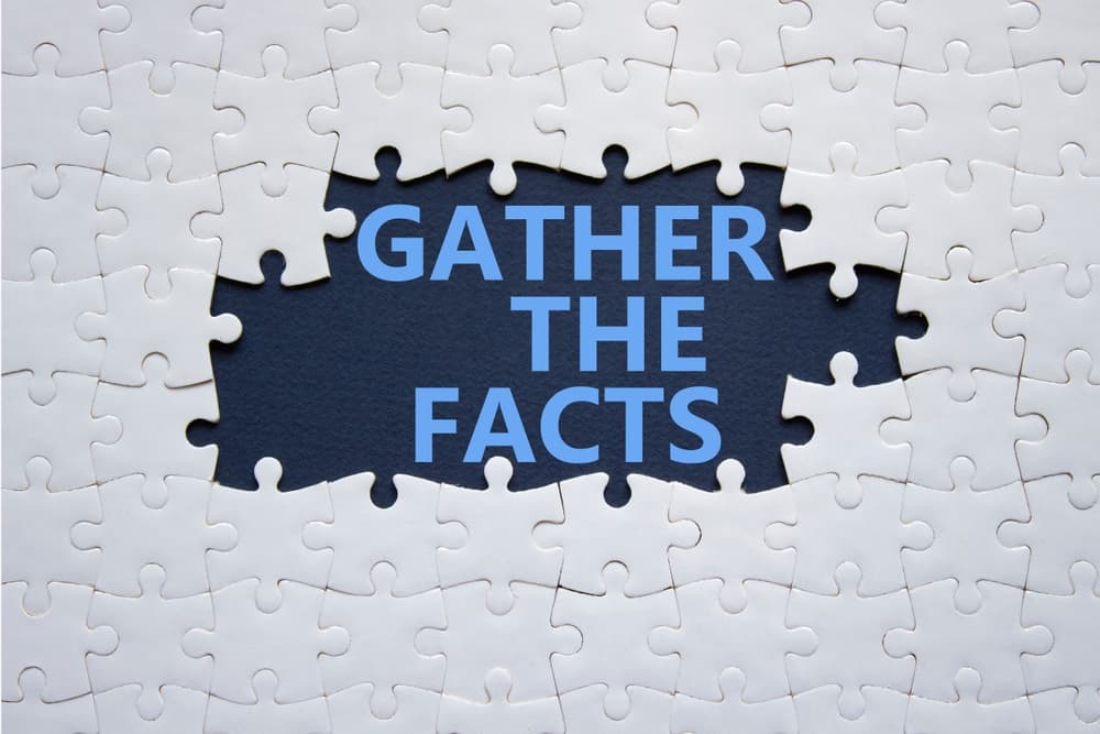 Symbol of gathering facts: 'Gather the facts' on white puzzle against deep blue background. Business concept.