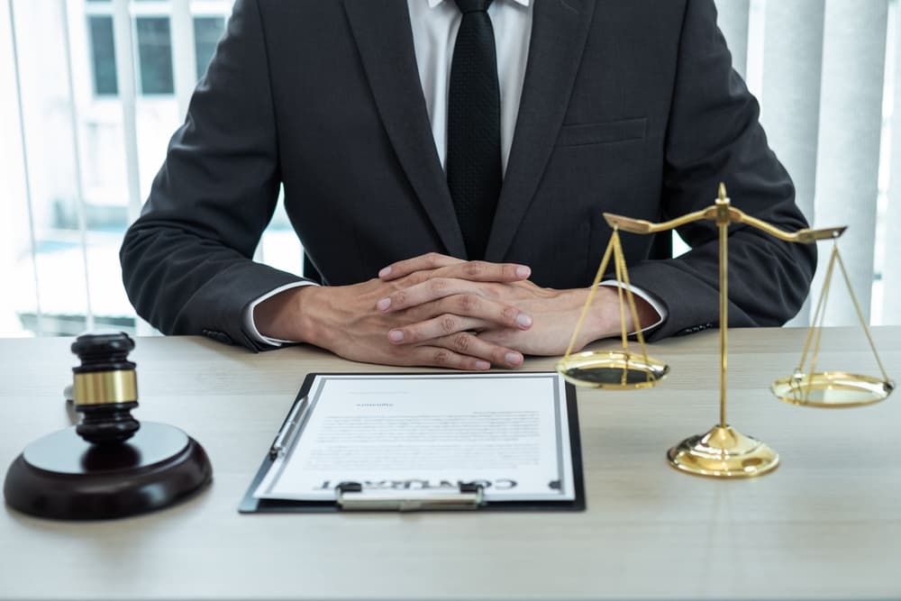 Male lawyer reviewing legal case document contract in office. Concept of law, justice, attorney, lawsuit.