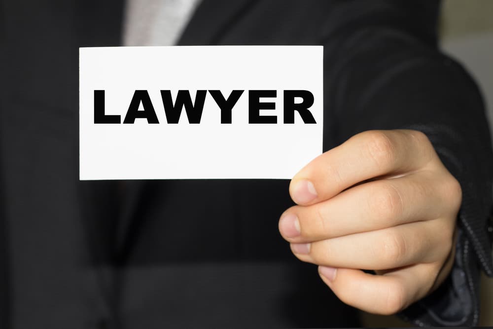 Card with text LAWYER on hand