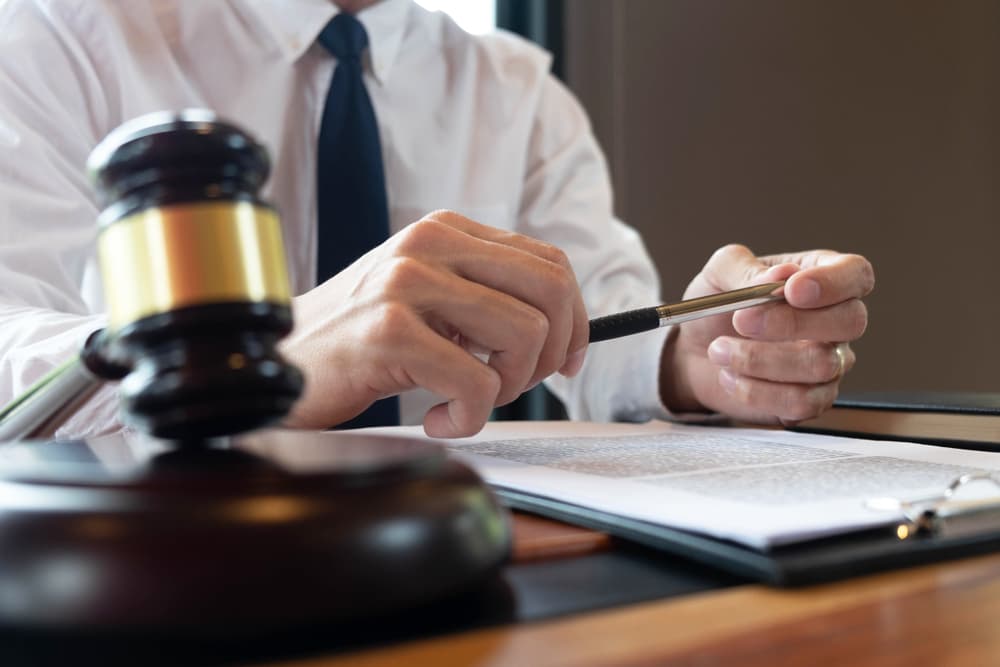 lawyer in his office holding a pen in hands