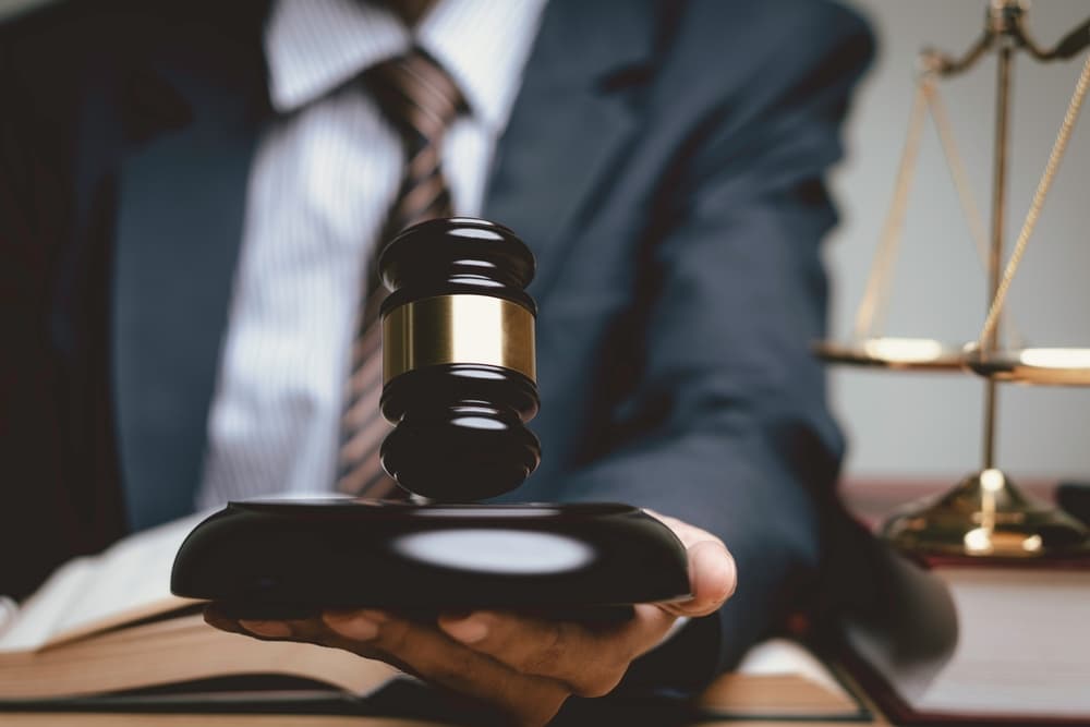 A lawyer holding judge's gavel in his left hand