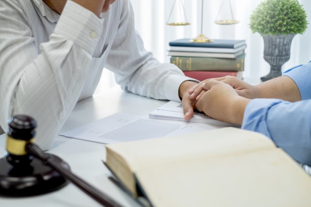 lawyer who gives advice and shows consolation with his client.