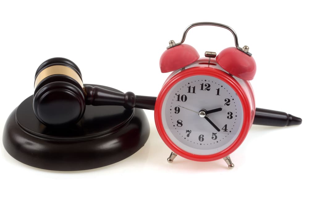 A time clock alongwith wooden gavel