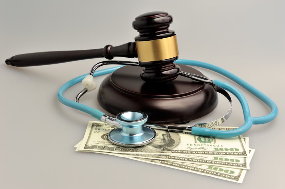 Stethoscope with judge gavel, money