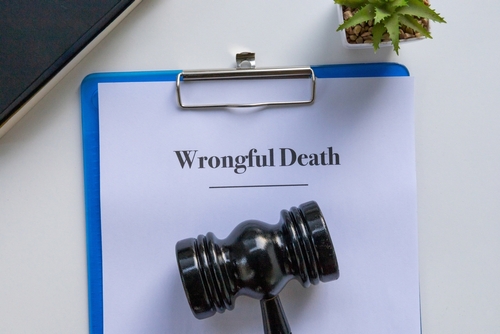A clipboard labeled “Wrongful Death” with a judge’s gavel resting on it, symbolizing legal action and justice for a wrongful death claim.