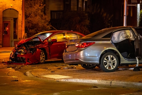 Two heavily damaged vehicles at a nighttime crash scene, reflecting the serious collisions often managed with the help of a Gainesville car accident lawyer.