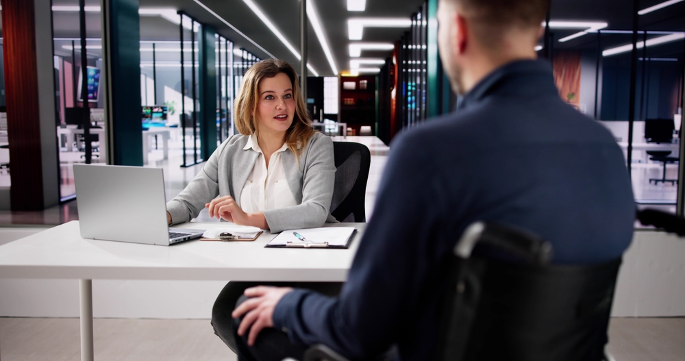 Attorney consulting with injured client in office setting, representing a Gainesville Slip and Fall Accident Lawyer reviewing a premises liability case.