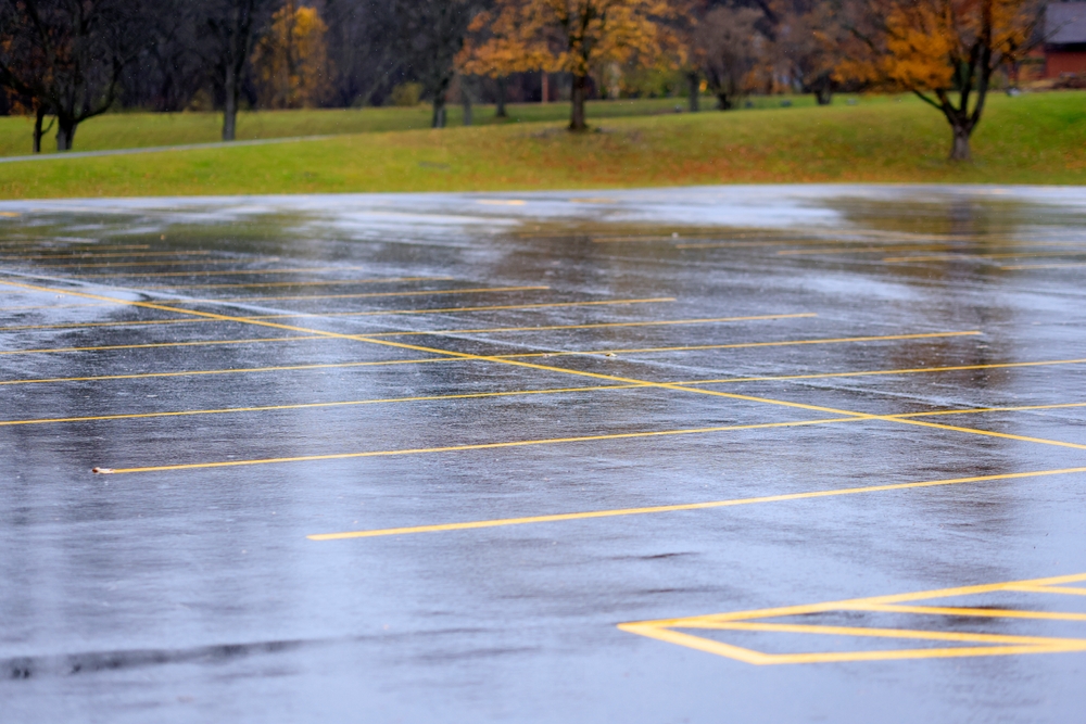 Rain-soaked parking lot with standing water, showing dangerous conditions reviewed by a Daytona Premises Liability Accident Lawyer.