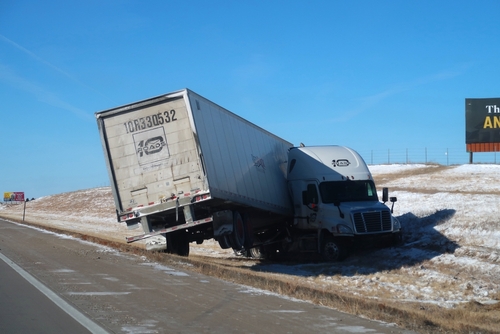 Jackknife truck accidents in Gainesville showing a semi-truck off the road after losing control in icy conditions.