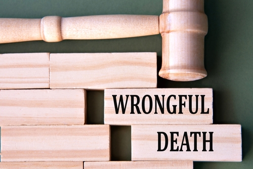 Gainesville wrongful death lawyer explains uninsured motorist coverage in fatal Gainesville accidents with legal symbols and documents.