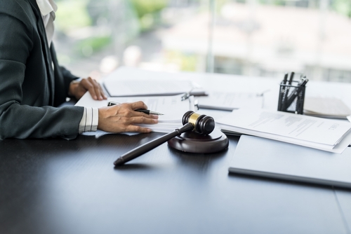 Gainesville truck accident lawyer reviewing legal documents with a gavel on the desk.