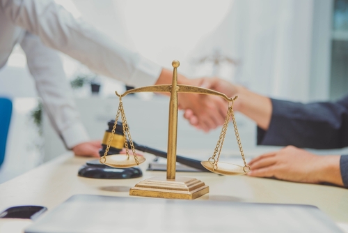 Gainesville brain injury lawyer discussing legal claims with clients and reviewing case details.