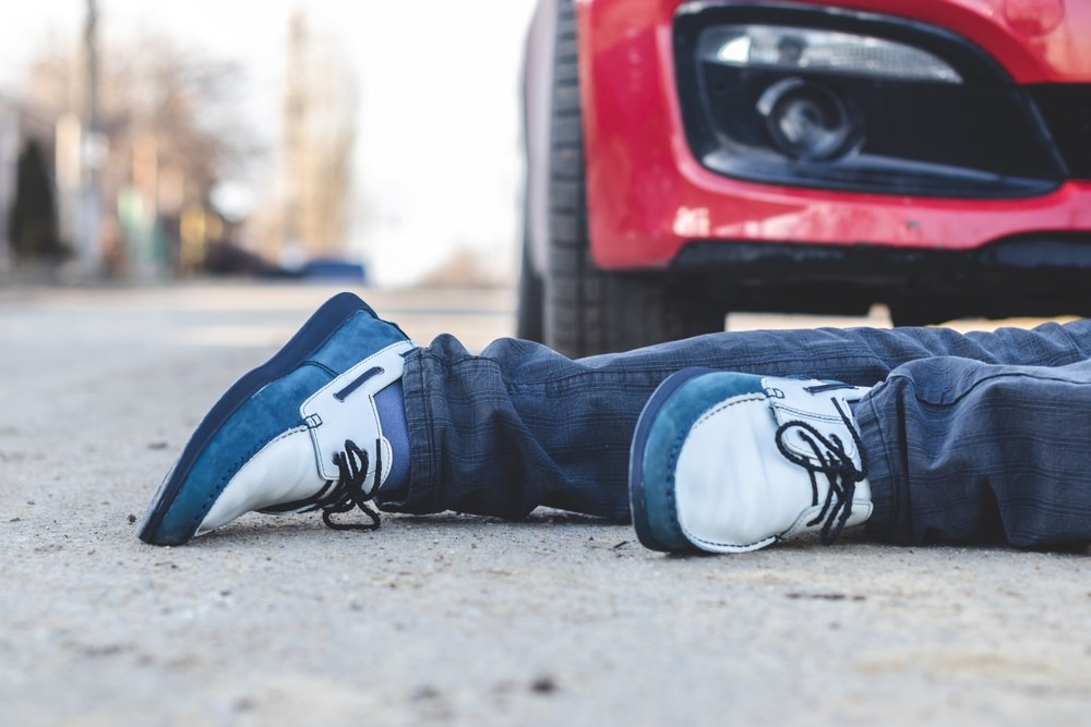 Pedestrian lying on the street in front of a car after being struck in a Duckpond Gainesville accident