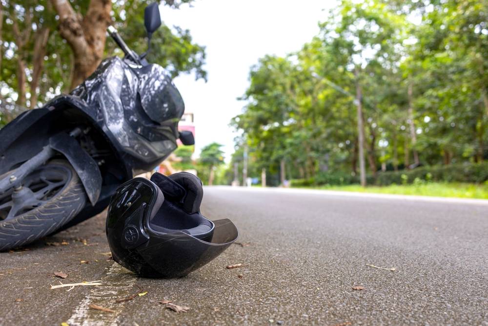 Motorcycle and helmet on the pavement after a crash on SR-40 in Ocala National Forest