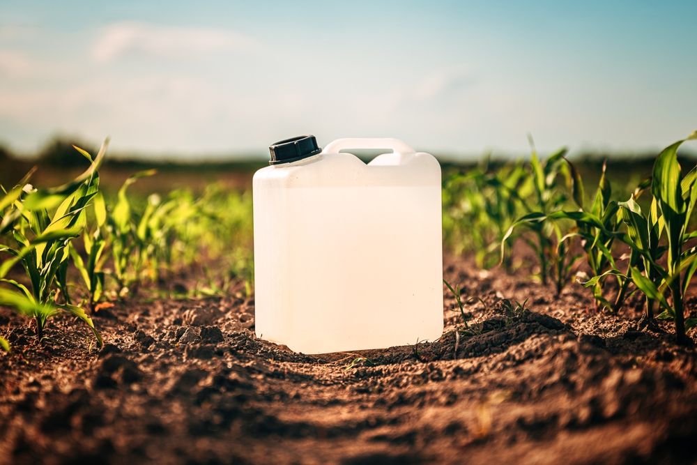 Herbicide container in a farm field where Dacthal was used