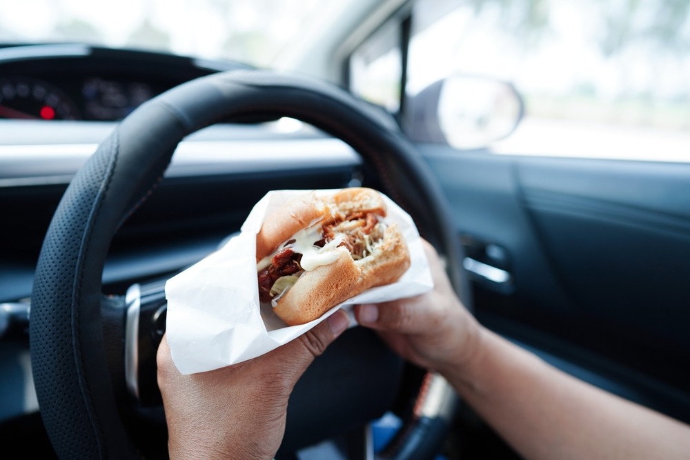 Driver eating food while driving, a form of manual distraction