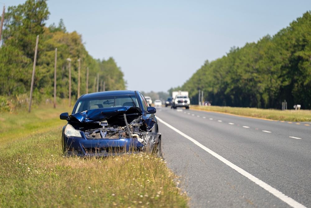 Wrecked car left on the roadside after a hit-and-run crash