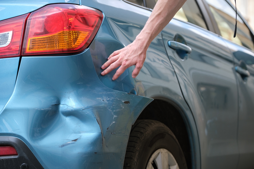Wrecked car left on the roadside after a hit-and-run crash